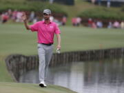 Webb Simpson waves as he walks to the 18th hole during the final round of the Players Championship golf tournament, Sunday, May 13, 2018, in Ponte Vedra Beach, Fla. Simpson won the tournament.