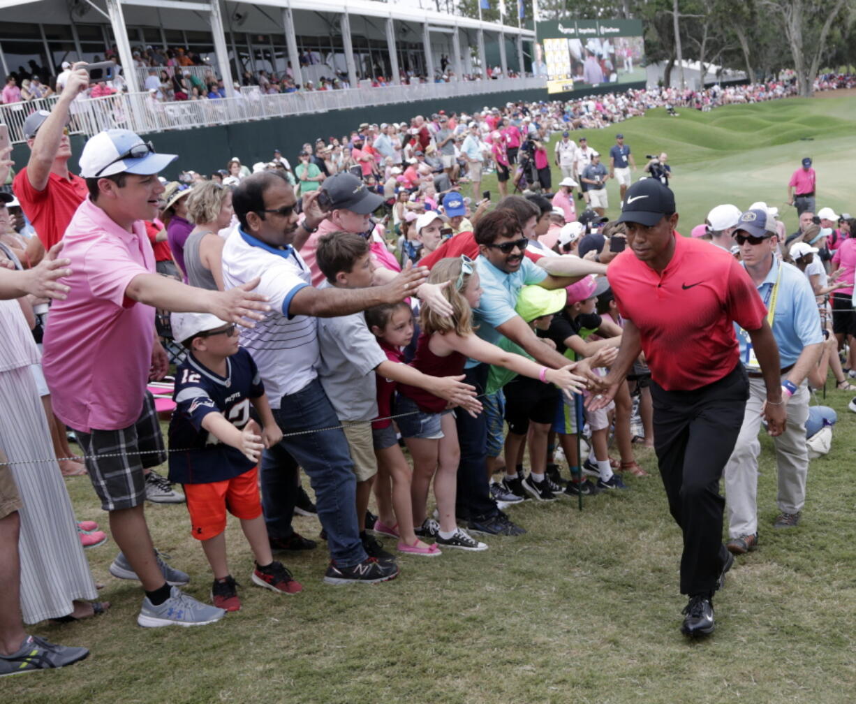 Fans greet Tiger Woods as he exits the 18 hole, during the final round of The Players Championship golf tournament Sunday, May 13, 2018, in Ponte Vedra Beach, Fla.