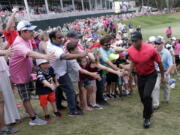 Fans greet Tiger Woods as he exits the 18 hole, during the final round of The Players Championship golf tournament Sunday, May 13, 2018, in Ponte Vedra Beach, Fla.