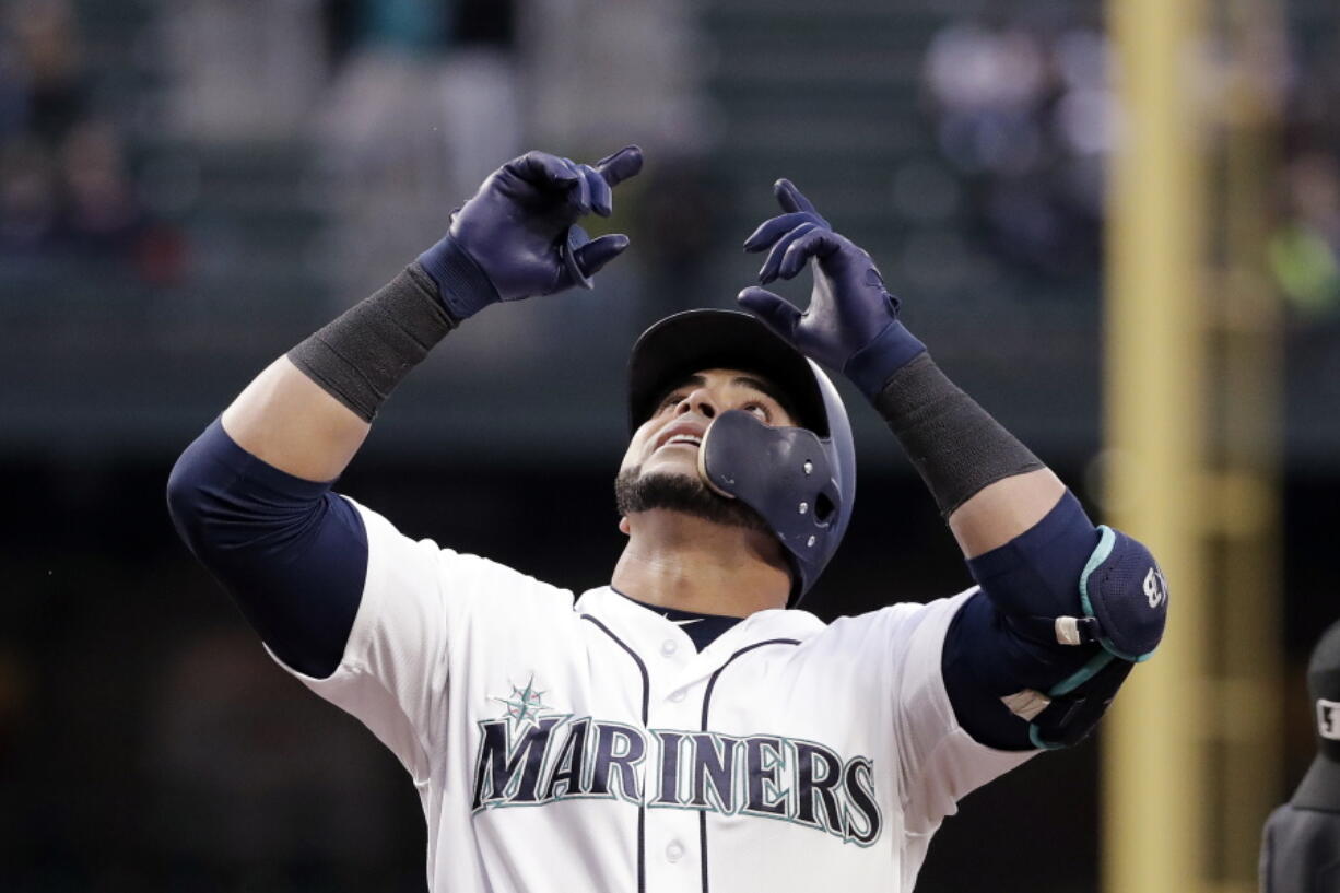 Seattle Mariners’ Nelson Cruz points skyward as he crosses home on his two-run home run against the Texas Rangers during the third inning of a baseball game Thursday, May 31, 2018, in Seattle.