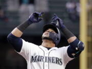 Seattle Mariners’ Nelson Cruz points skyward as he crosses home on his two-run home run against the Texas Rangers during the third inning of a baseball game Thursday, May 31, 2018, in Seattle.