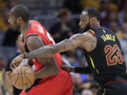 Cleveland Cavaliers’ LeBron James (23) strips the ball from Toronto Raptors’ Serge Ibaka in the first half of Game 4 of an NBA basketball second-round playoff series, Monday, May 7, 2018, in Cleveland.