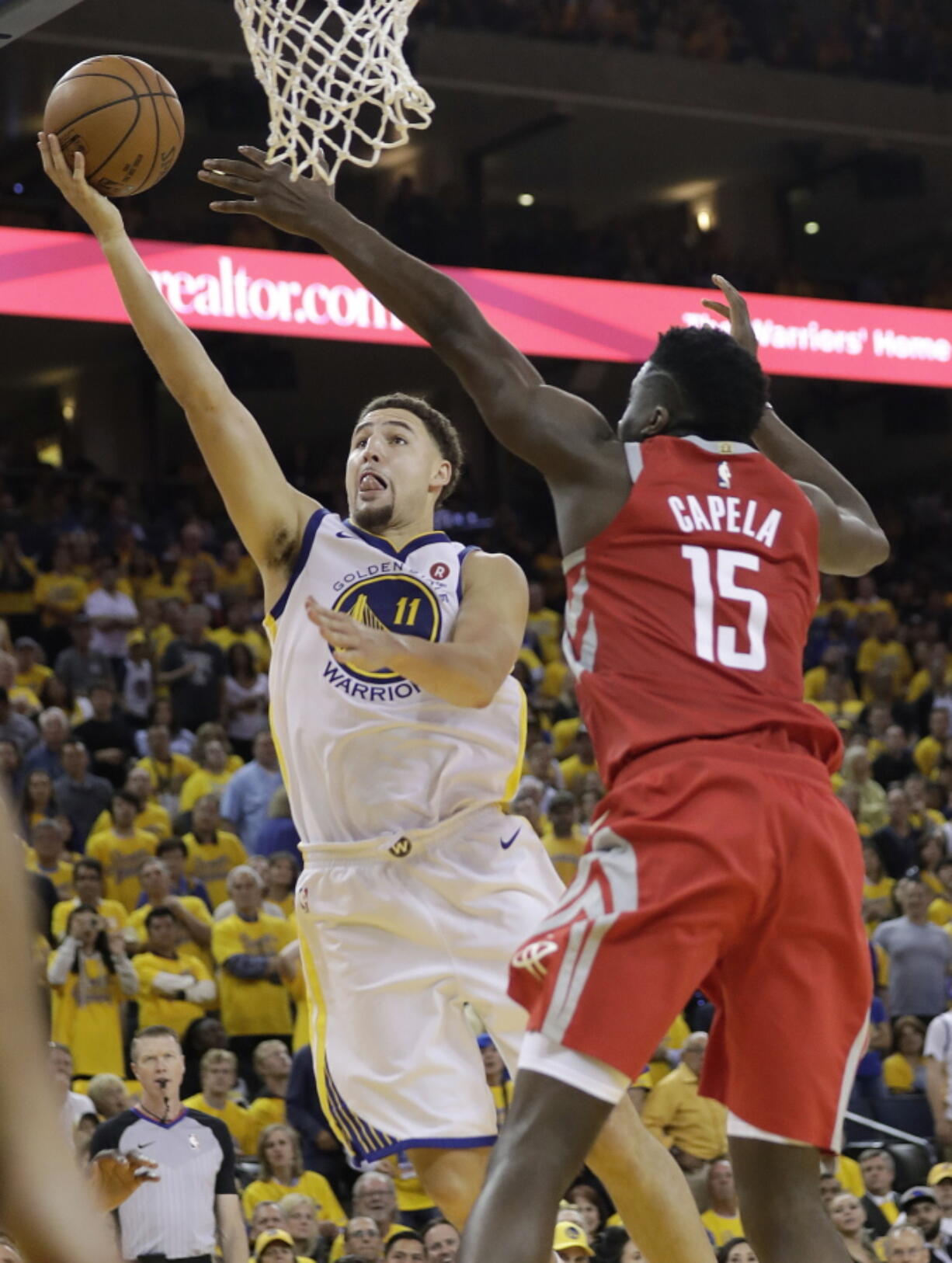 Golden State Warriors guard Klay Thompson (11) shoots against Houston Rockets center Clint Capela (15) during the second half of Game 6 of the NBA basketball Western Conference Finals in Oakland, Calif., Saturday, May 26, 2018.