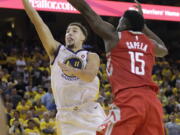 Golden State Warriors guard Klay Thompson (11) shoots against Houston Rockets center Clint Capela (15) during the second half of Game 6 of the NBA basketball Western Conference Finals in Oakland, Calif., Saturday, May 26, 2018.