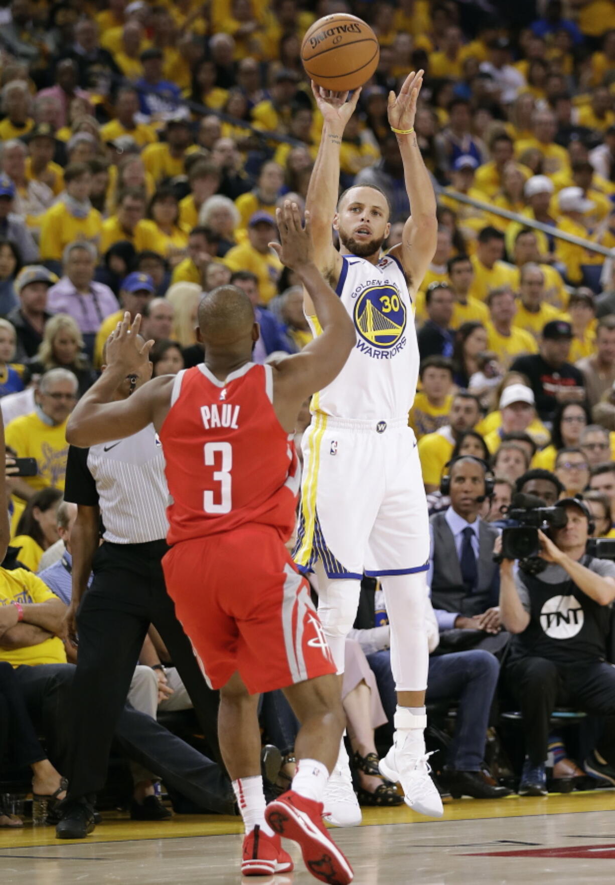 Golden State Warriors guard Stephen Curry (30) shoots against Houston Rockets guard Chris Paul (3) during the second half of Game 3 of the NBA basketball Western Conference Finals in Oakland, Calif., Sunday, May 20, 2018.