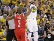 Golden State Warriors guard Stephen Curry (30) shoots against Houston Rockets guard Chris Paul (3) during the second half of Game 3 of the NBA basketball Western Conference Finals in Oakland, Calif., Sunday, May 20, 2018.