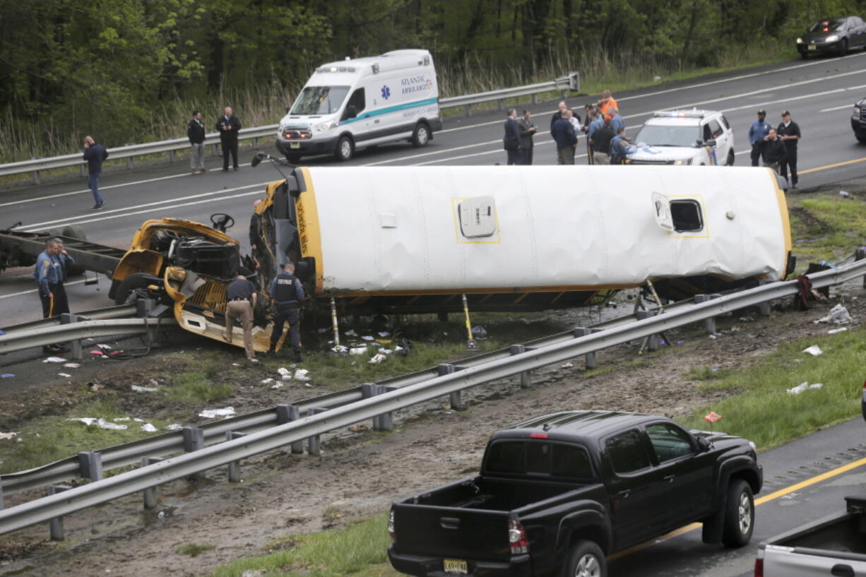 Emergency personnel work at the scene of a school bus and dump truck collision  on Interstate 80 in Mount Olive, N.J., on May 17.