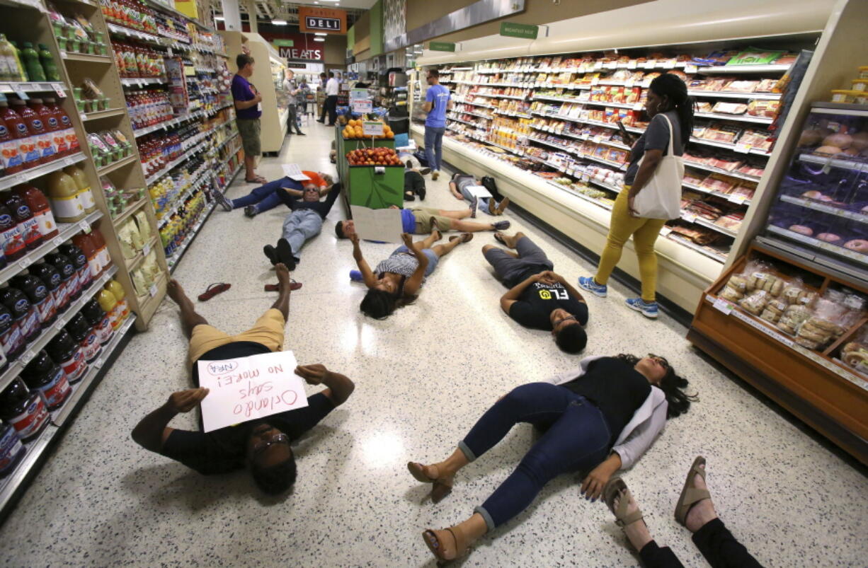 Demonstrators lay on the floor during a protest against gun violence at a Publix supermarket near downtown Orlando, Fla., on May 25.