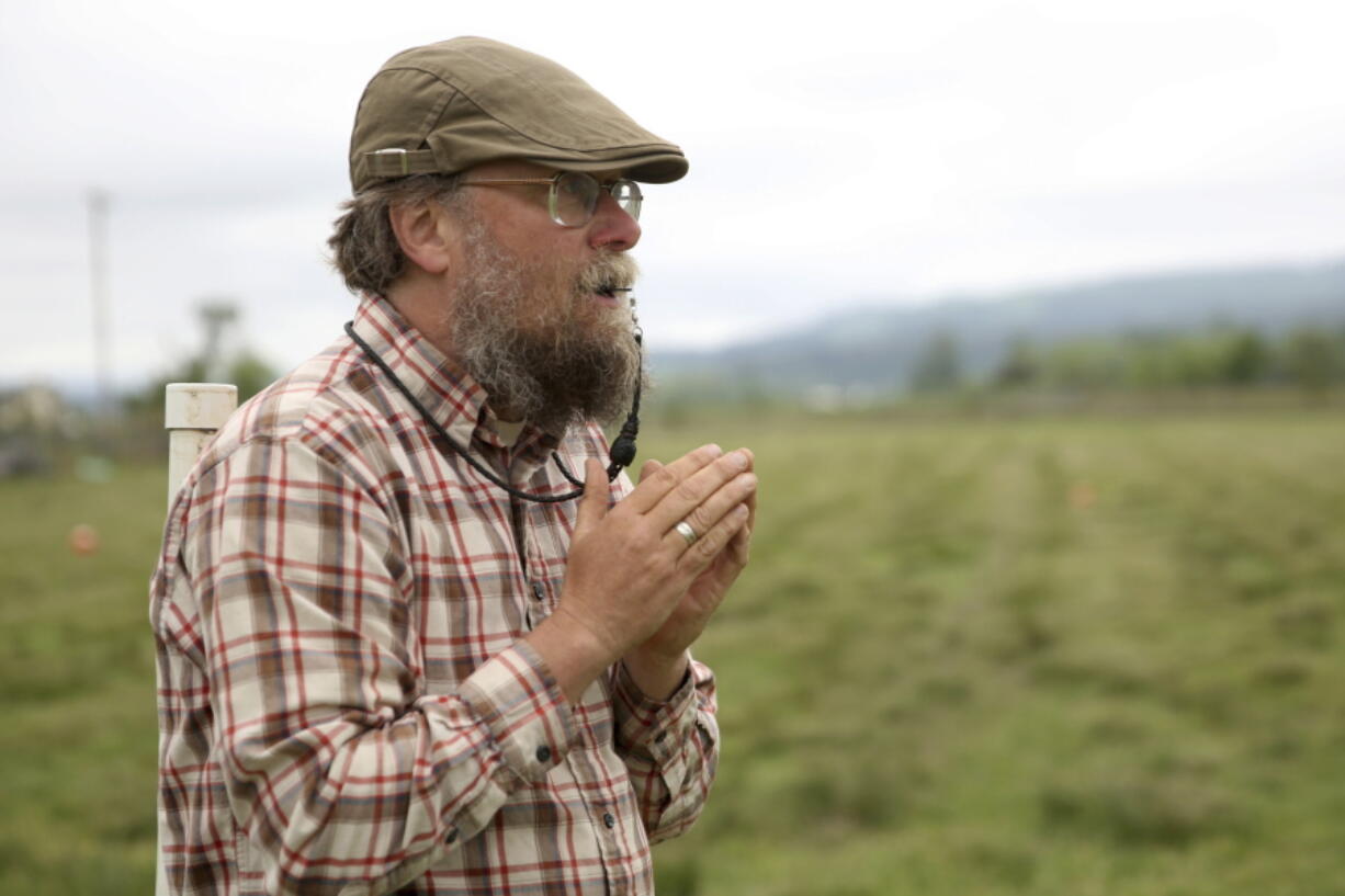 Ian Caldicott, 53, of Scio, uses a whistle to give commands to his sheepdogs before the 81st annual running of the Northwest Championship Sheepdog Trial at Wolston Farm in Scio on Thursday, May 17, 2018. The Sheepdog Trial has competitions on Friday, Saturday and Sunday in Scio.