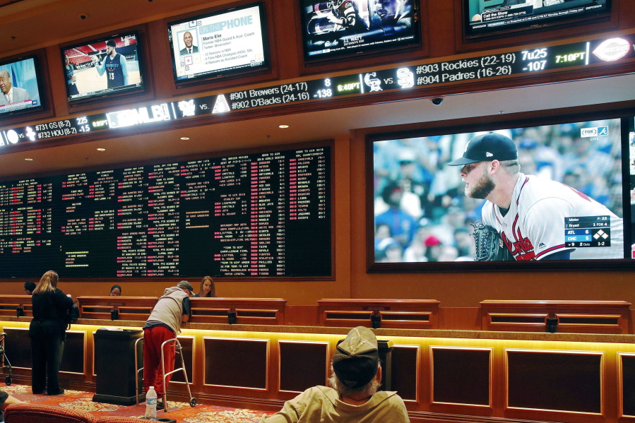 People make bets in the sports book area of the South Point Hotel and Casino in Las Vegas on May 14. Those who deal with compulsive gambling are worried that a rapid expansion of sports betting in the U.S. could cause more people to develop gambling problems. The U.S. Supreme Court on Monday cleared the way for states to legalize sports betting.