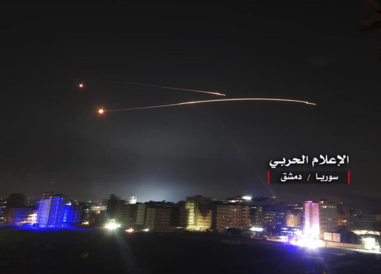 This photo provided early Thursday by the government-controlled Syrian Central Military Media, shows missiles rise into the sky as Israeli missiles hit air defense position and other military bases, in Damascus, Syria. The Israeli military on Thursday said it attacked “dozens” of Iranian targets in neighboring Syria in response to an Iranian rocket barrage on Israeli positions in the Golan Heights, in the most serious military confrontation between the two bitter enemies to date.