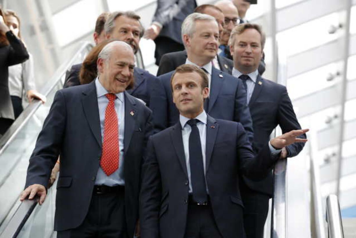 French President Emmanuel Macron, right, and Organisation for Economic Co-operation and Development (OECD) Secretary-General Angel Gurria arrive at the OECD ministerial council meeting on "Refounding Multilateralism", in Paris, France, Wednesday, May 30, 2018. Macron warned against trade wars in an impassioned speech about international cooperation Wednesday, two days before the Trump administration decides whether to hit Europe with punishing new tariffs.