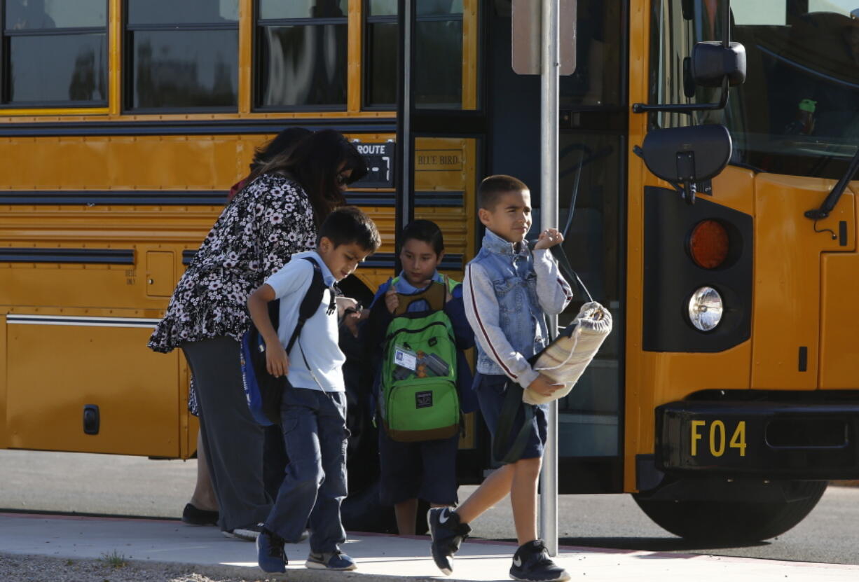 Several Arizona schools resume classes as students return to Tuscano Elementary School Thursday, May 3, 2018, in Phoenix. After an all night legislative budget session the legislature passed the new education spending portion of the budget and Republican Gov. Doug Ducey signed that part of the budget. (AP Photo/Ross D.