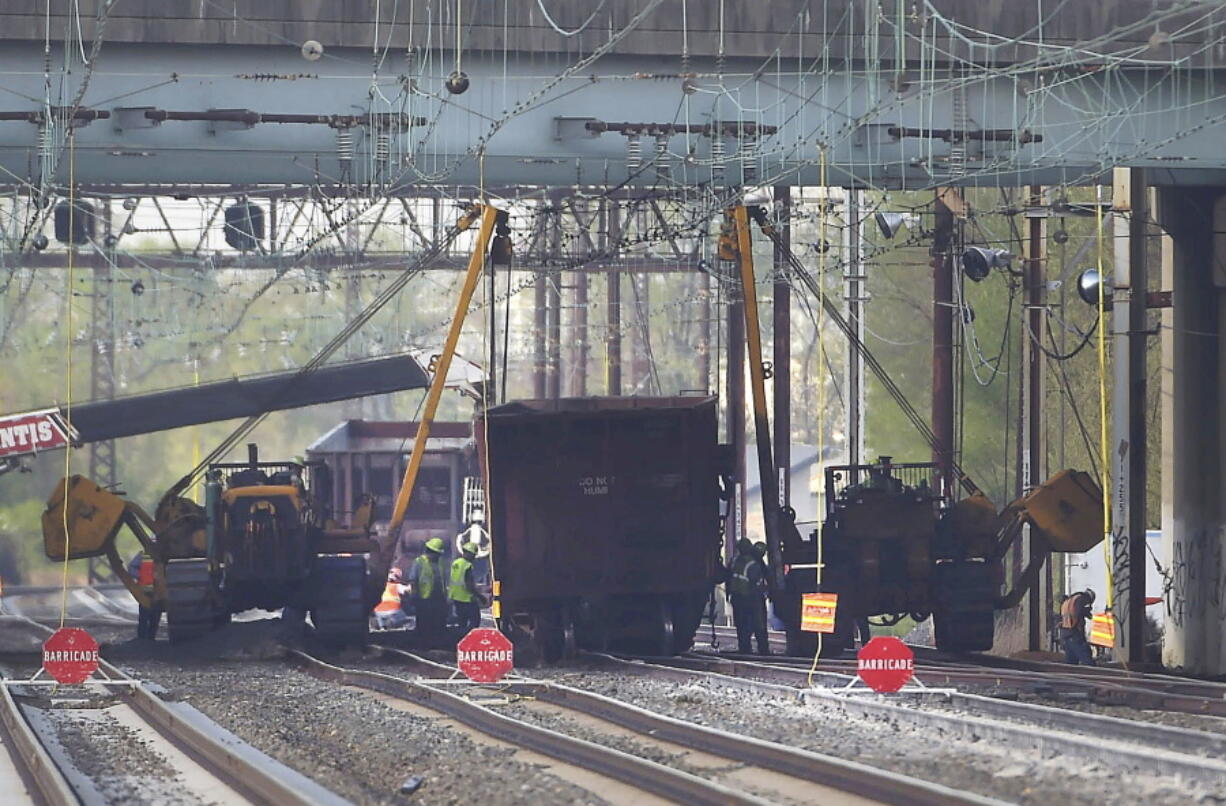 Emergency personnel work at the scene after multiple cars from a Norfolk Southern freight train detailed in Ridley Park, Pa., on Thursday. Amtrak said service between Philadelphia and Washington has been temporarily suspended due to the derailment.