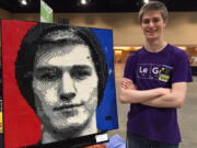 This June 2017 photo taken at Brickworld Chicago in Schaumburg, Ill., shows Chicago-area college student Casey McCoy and the self-portrait he created from more than 3,000 Lego bricks. Every June, Lego enthusiasts from around the world descend on Schaumburg, a northwestern suburb of Chicago, to build Legos, display Legos, play Legos, swap Legos, win Legos and more. This year’s convention is June 13-17.