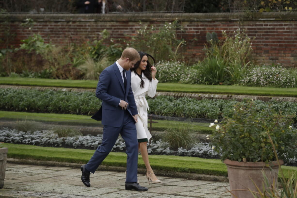 Britain’s Prince Harry and his fiancee Meghan Markle pose for photographers Nov. 27 during a photocall in the grounds of Kensington Palace. Fans of the British royals will want to include castles, Westminster Cathedral and other sites connected to Queen Elizabeth II and her family on any trip to England.