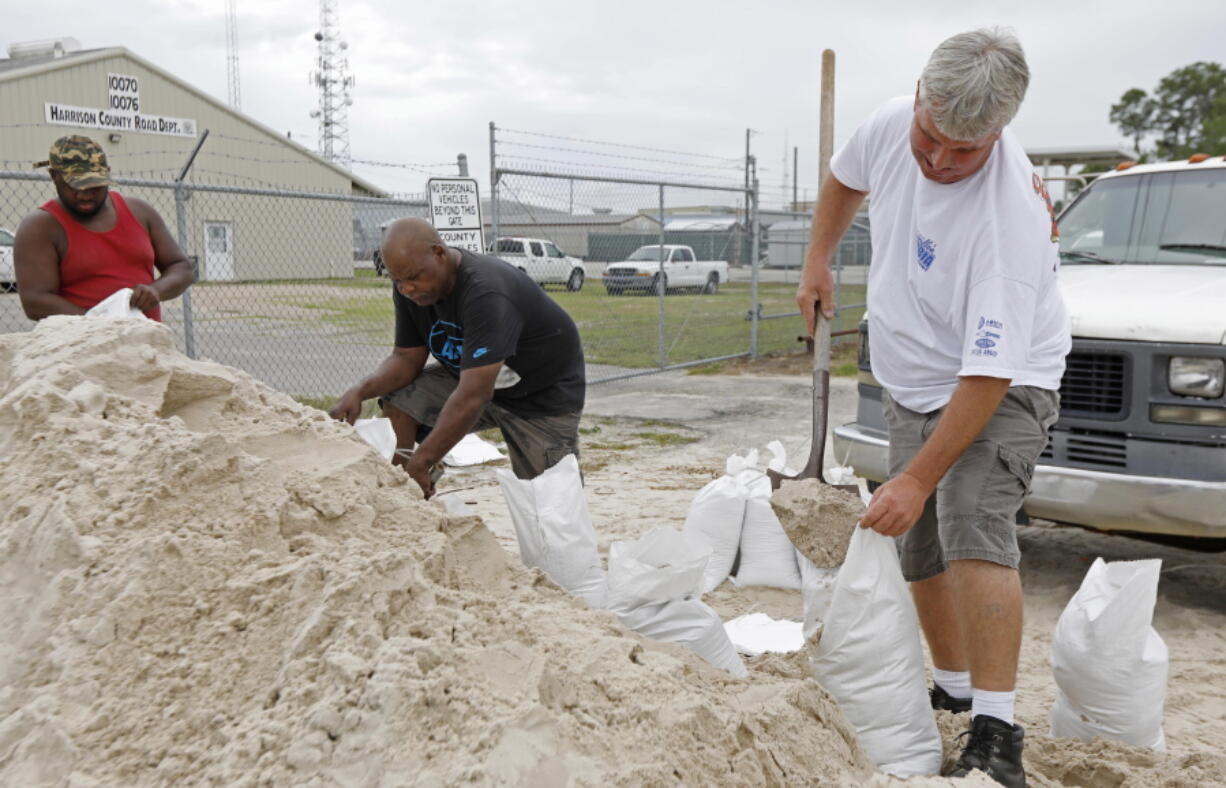 Gulfport, Miss., residents shovel sand into bags at a Harrison County Road Department sand bagging location, while preparing for Subtropical Storm Alberto to make its way through the Gulf of Mexico, Saturday. The slow moving storm is threatening to bring heavy rainfall, storm surges, high wind and flash flooding this holiday weekend. (AP Photo/Rogelio V.