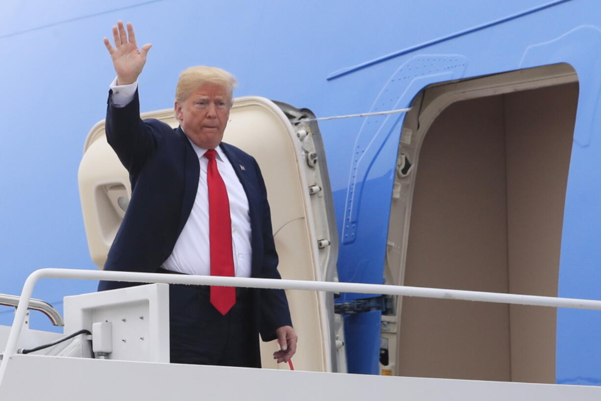 President Donald Trump waves as he boards Air Force One at Andrews Air Force Base, Md., on Thursday for a trip to Houston, Texas, to meet the Santa Fe family members and community leaders.