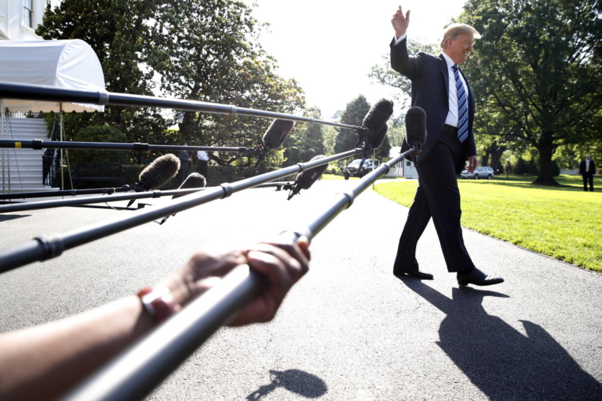 President Donald Trump waves while walking away after speaking to the media, as he walks to the Marine One helicopter on the South Lawn of the White House in Washington on May 25.