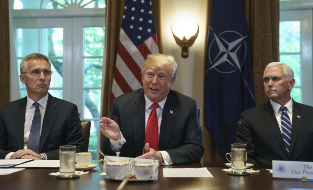 President Donald Trump joined by NATO Secretary General Jens Stoltenberg, left, and Vice President Mike Pence, right, speaks during an expanded bilateral meeting in the Cabinet Room of the White House, in Washington, Thursday, May 17, 2018.