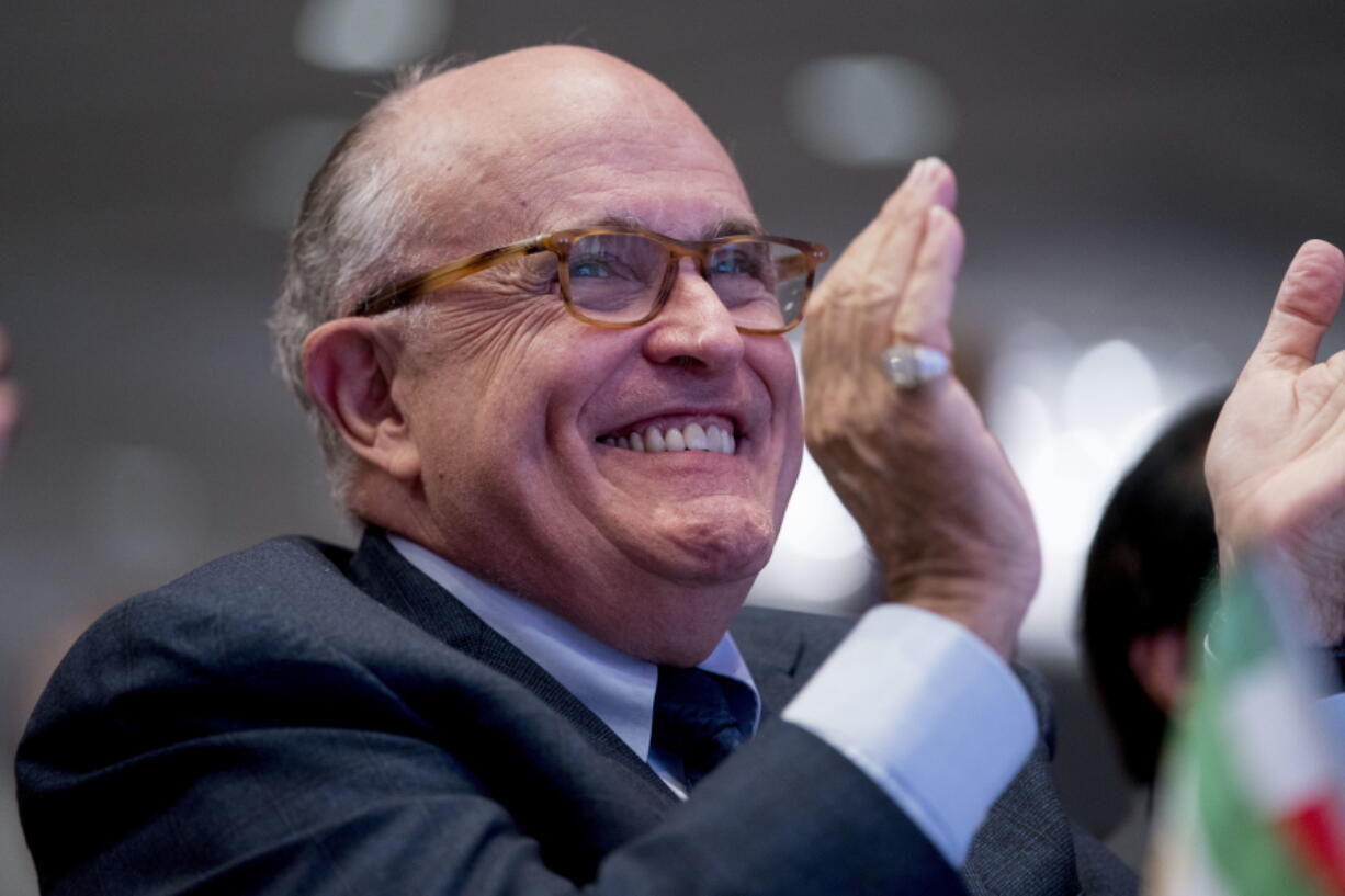 Rudy Giuliani, an attorney for President Donald Trump, applauds at the Iran Freedom Convention for Human Rights and democracy at the Grand Hyatt in Washington. Giuliani’s decision to join President Donald Trump’s legal team could backfire on the former New York mayor if potential clients of his international consulting business view him as too erratic and go elsewhere for representation, according to legal experts.