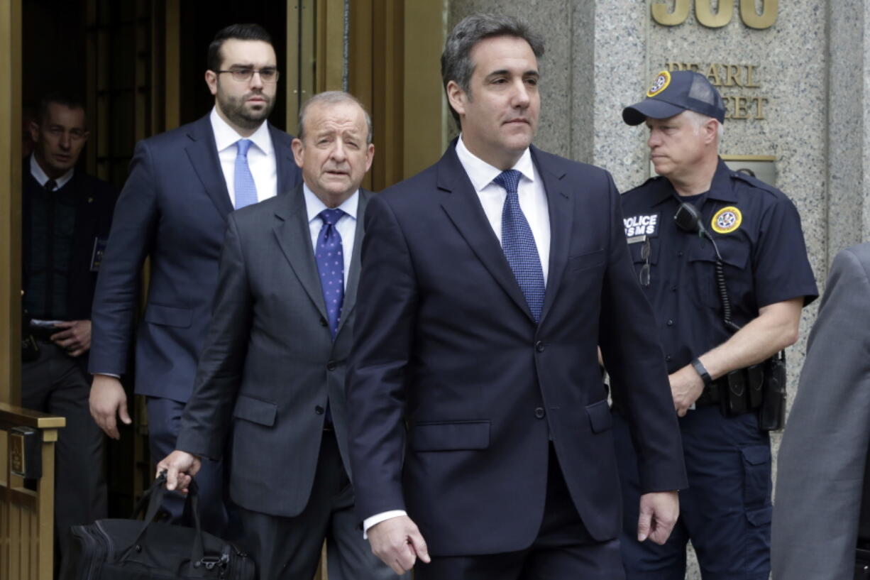 President Donald Trump’s personal attorney Michael Cohen, right, leaves Federal Court, in New York on Wednesday. U.S. District Judge Kimba Wood said at a hearing Wednesday that she had to balance the needs of lawyers for Cohen and Trump with the needs of criminal prosecutors.