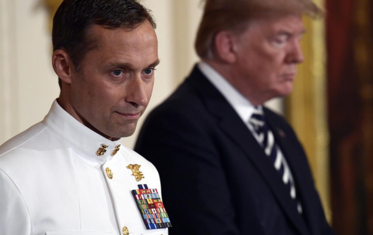 President Donald Trump stands with Master Chief Special Warfare Operator Britt K. Slabinski during a ceremony to award him the Medal of Honor in the East Room of the White House in Washington, Thursday, May 24, 2018.