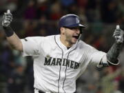 Seattle Mariners Mike Zunino celebrates after he hit a walk-off solo home run against the Minnesota Twins during the 12th inning of a baseball game, Saturday, May 26, 2018, in Seattle. The Mariners won 4-3. (AP Photo/Ted S.