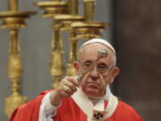 Pope Francis asperges holy water as he celebrates a Pentecost mass in St. Peter’s Basilica at the Vatican on Sunday.