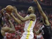 Golden State Warriors forward Kevin Durant (35) drives to the basket past Houston Rockets guard James Harden (13) during the first half of Game 1 of the NBA basketball Western Conference Finals, Monday, May 14, 2018, in Houston. (AP Photo/David J.