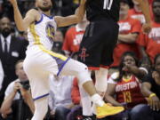 Houston Rockets guard Eric Gordon, right, blocks a shot by Golden State Warriors guard Stephen Curry during the second half in Game 5 of the NBA basketball playoffs Western Conference finals in Houston, Thursday, May 24, 2018. (AP Photo/David J.