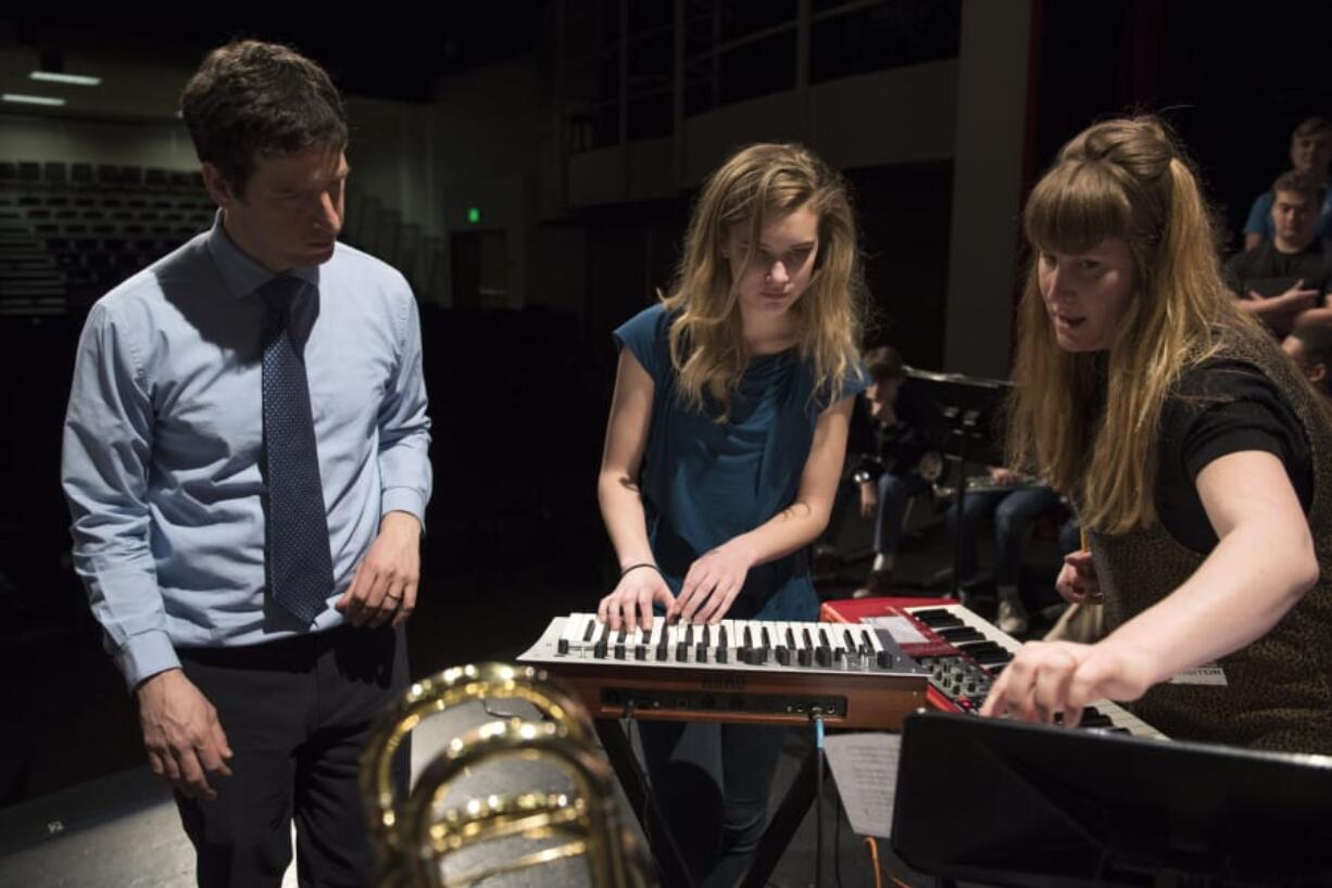 Camas High School Choir director Ethan Chessin, left, seen in March, earned a Give A Note Foundation Music Education Innovator Award for his program, The Business of Music program.