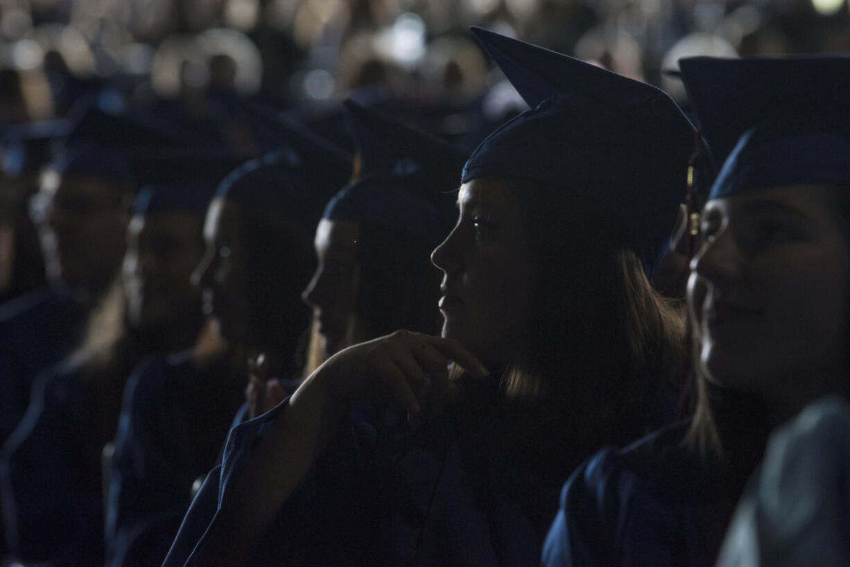 Clark College students listen to a commencement speaker during the 2018 Clark College Commencement Ceremony at the Sunlight Supply Amphitheater on Thursday.