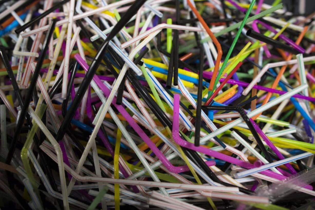 Used flexible drinking straws sit in a bin at the Coca-Cola factory in Dongen, Netherlands.