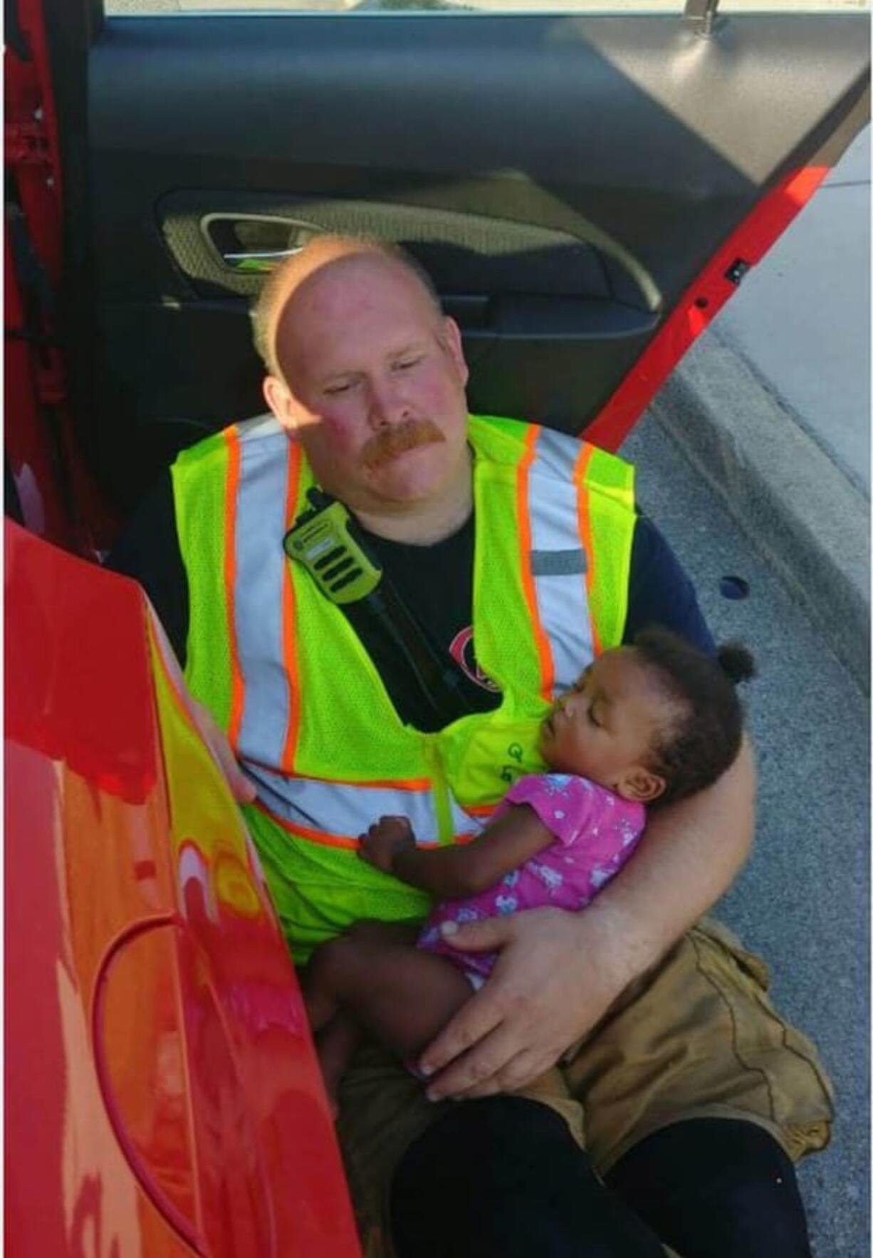 Chattanooga firefighter Chris Blazek calmed this baby after a car crash.