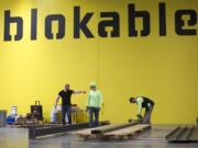 Workers assemble components at Blokable’s production facilities during a recent visit from Gov. Jay Inslee. The Seattle company makes its modular housing units — called bloks — in Vancouver.