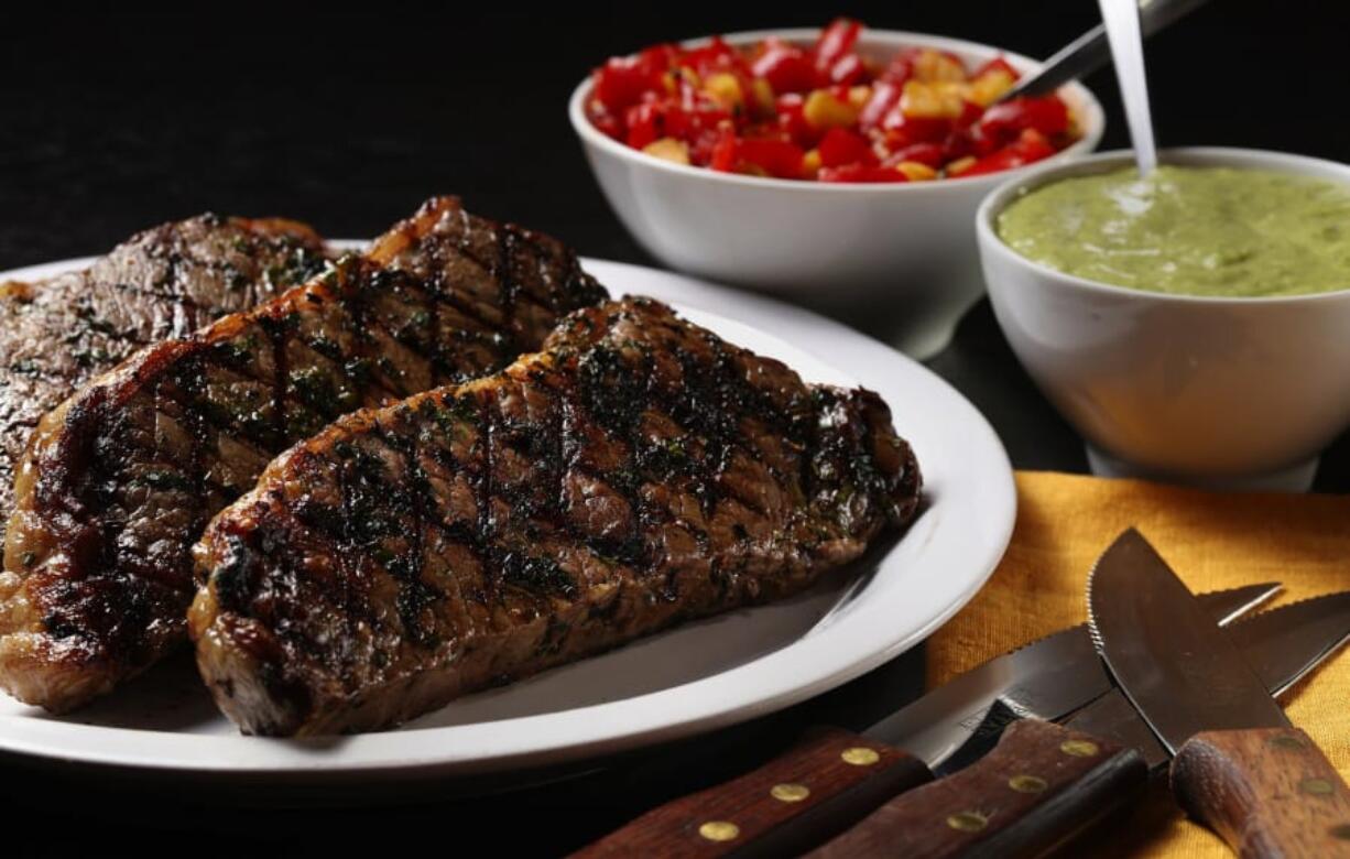 Put a combination of flavors and textures alongside the grilled steaks with a pair of condiments, a creamy avocado-lemongrass sauce and a tomato-lemon relish.