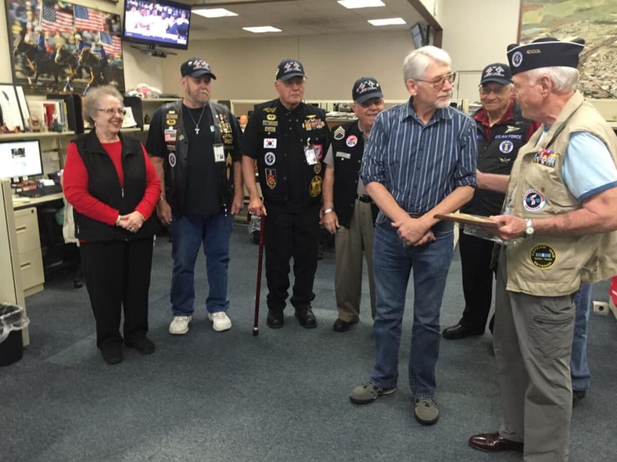 The Columbian files Tom Vogt, in blue, is honored by a veterans group for his many stories on military veterans and their service to America.