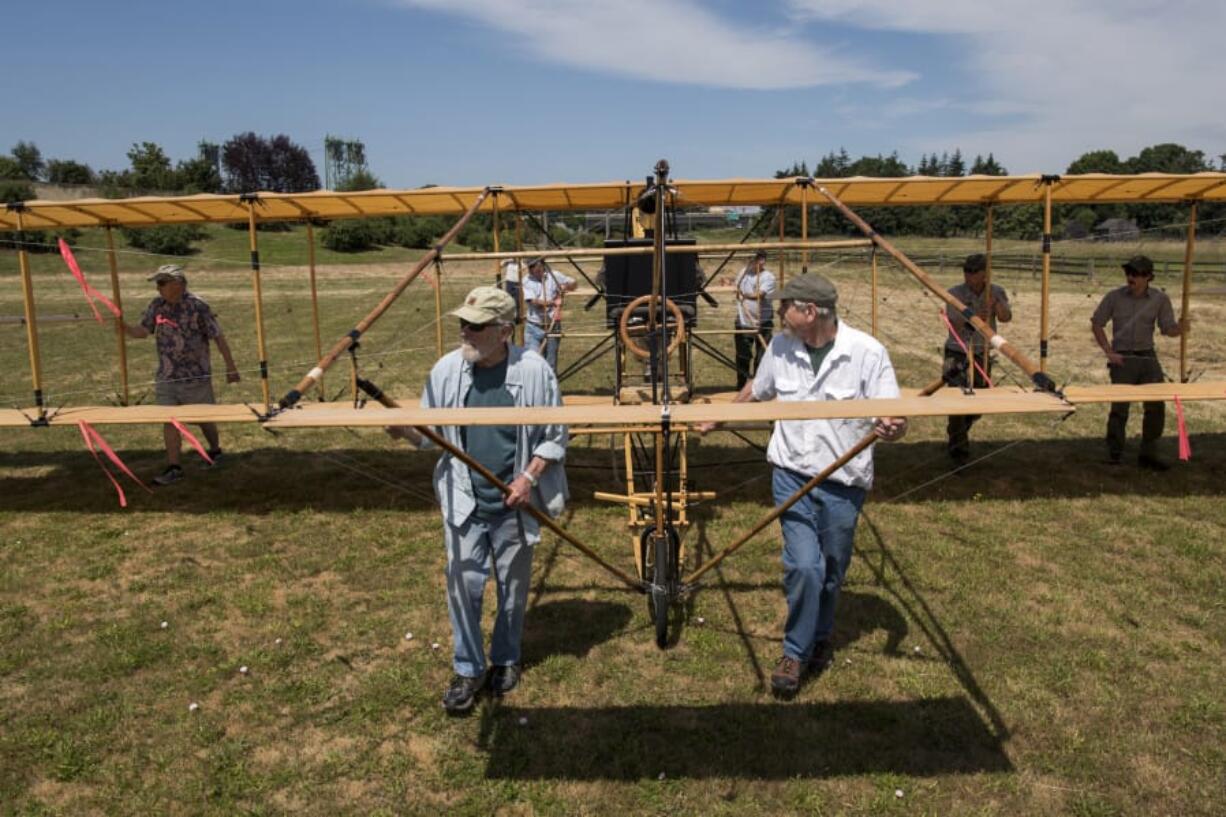 The team of volunteers who built the full-size 1912 replica biplane and Fort Vancouver staff move the plane Tuesday to Pearson Air Museum at Fort Vancouver National Historic Site.