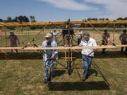 The team of volunteers who built the full-size 1912 replica biplane and Fort Vancouver staff move the plane Tuesday to Pearson Air Museum at Fort Vancouver National Historic Site.