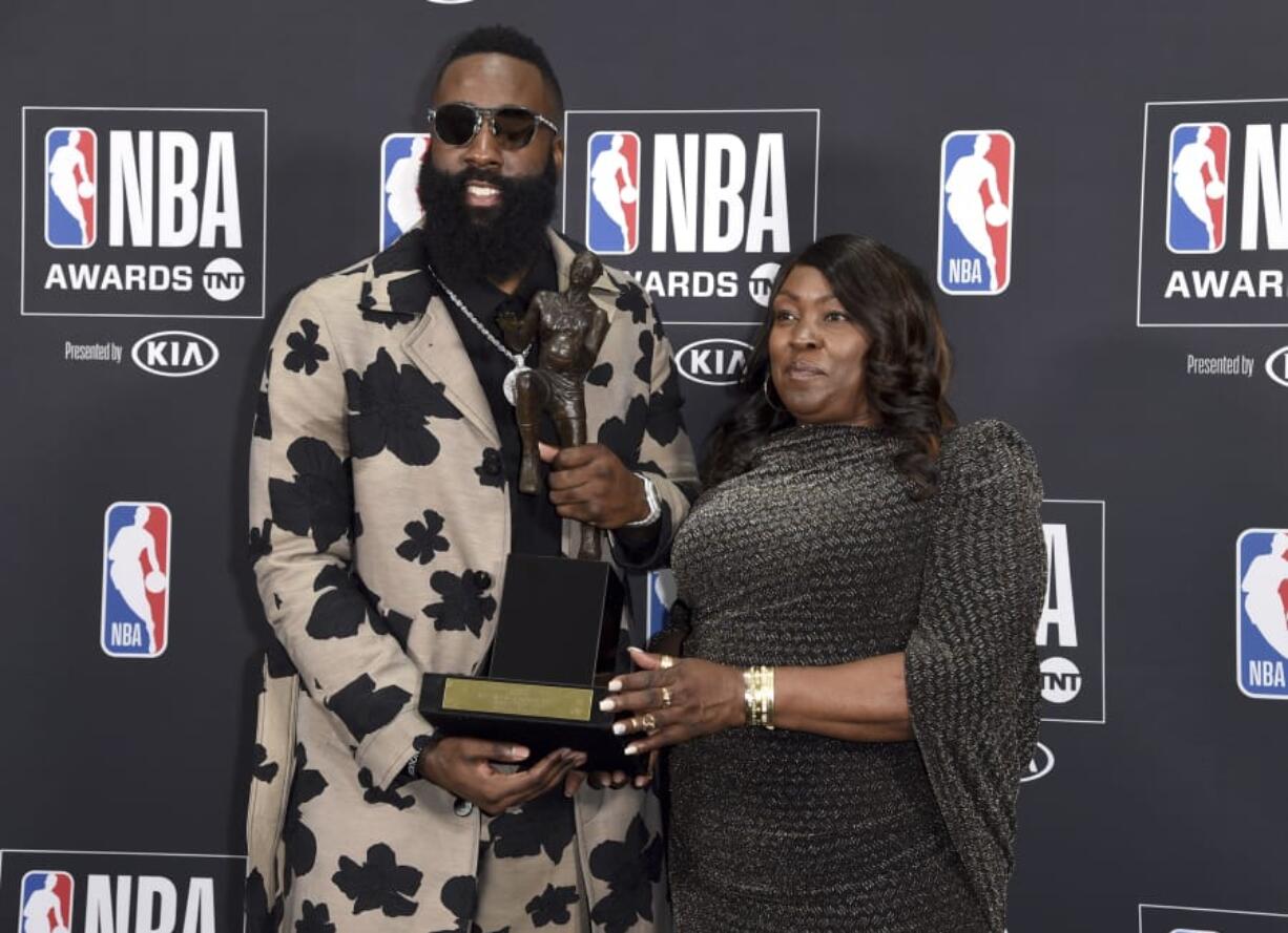 NBA player James Harden, of the Houston Rockets, left, winner of the most valuable player award, poses in the press room with his mother Monja Willis at the NBA Awards on Monday, June 25, 2018, at the Barker Hangar in Santa Monica, Calif.