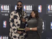 NBA player James Harden, of the Houston Rockets, left, winner of the most valuable player award, poses in the press room with his mother Monja Willis at the NBA Awards on Monday, June 25, 2018, at the Barker Hangar in Santa Monica, Calif.