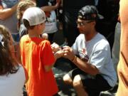 Oregon State’s Preston Jones signs autographs Friday in Portland, where a rally was held to celebrate the Beavers’ third national baseball title. Jones, a sophomore outfielder from Vancouver, appeared in six of the Beavers’ eight games at the College World Series in Omaha, Neb., including Thursday’s title-clinching win over Arkansas.