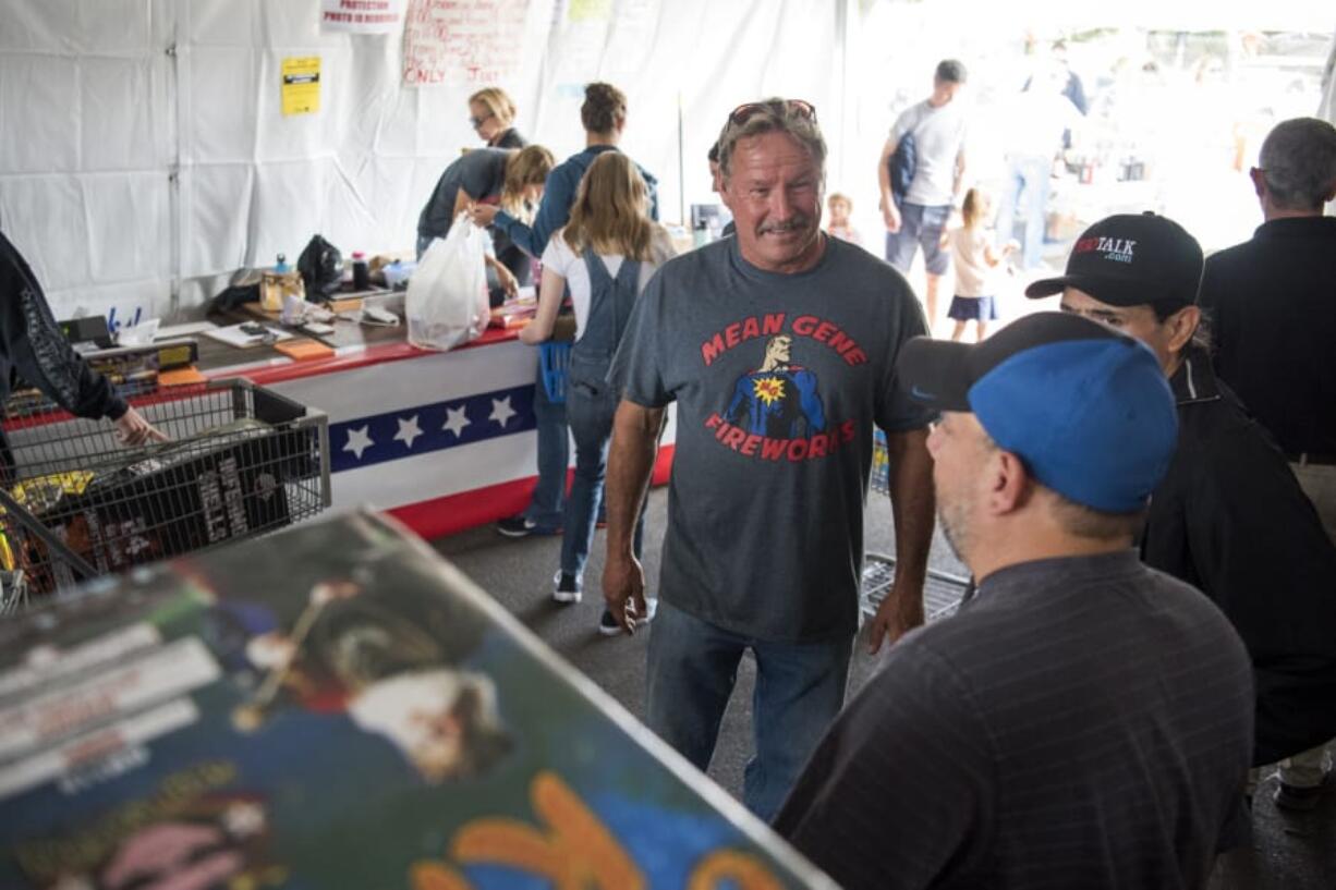 Mean Gene Fireworks owner Gene Marlow talks with customers at one of his fireworks stands on opening day.