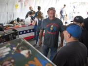 Mean Gene Fireworks owner Gene Marlow talks with customers at one of his fireworks stands on opening day.