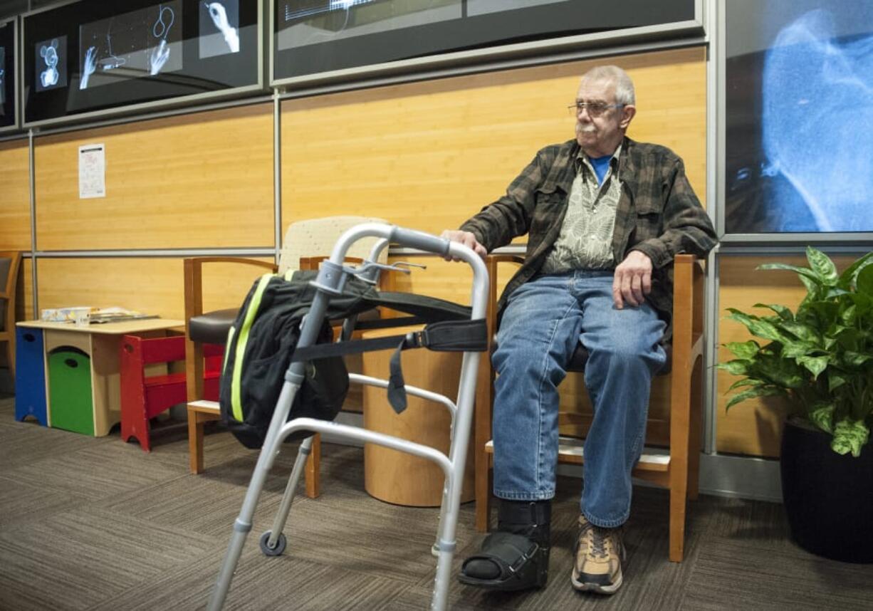 Melvin King waits for his appointment in the waiting room of the Rebound Orthopedics clinic at PeaceHealth Southwest Medical Center. King had both of his legs broken in a January hit-and-run in downtown Vancouver.