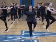 Mountain View High School senior Teresa Buchholz demonstrates across the floor exercises to the younger dancers during dance team tryouts at the high school on May 23.