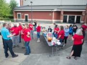 Members of the Washougal Association of Educators chat while waiting to hear updates from their contract negotiations with the school district at Washougal High School in June. The Washougal Association of Educators held a tailgate outside the high school during the negotiations.