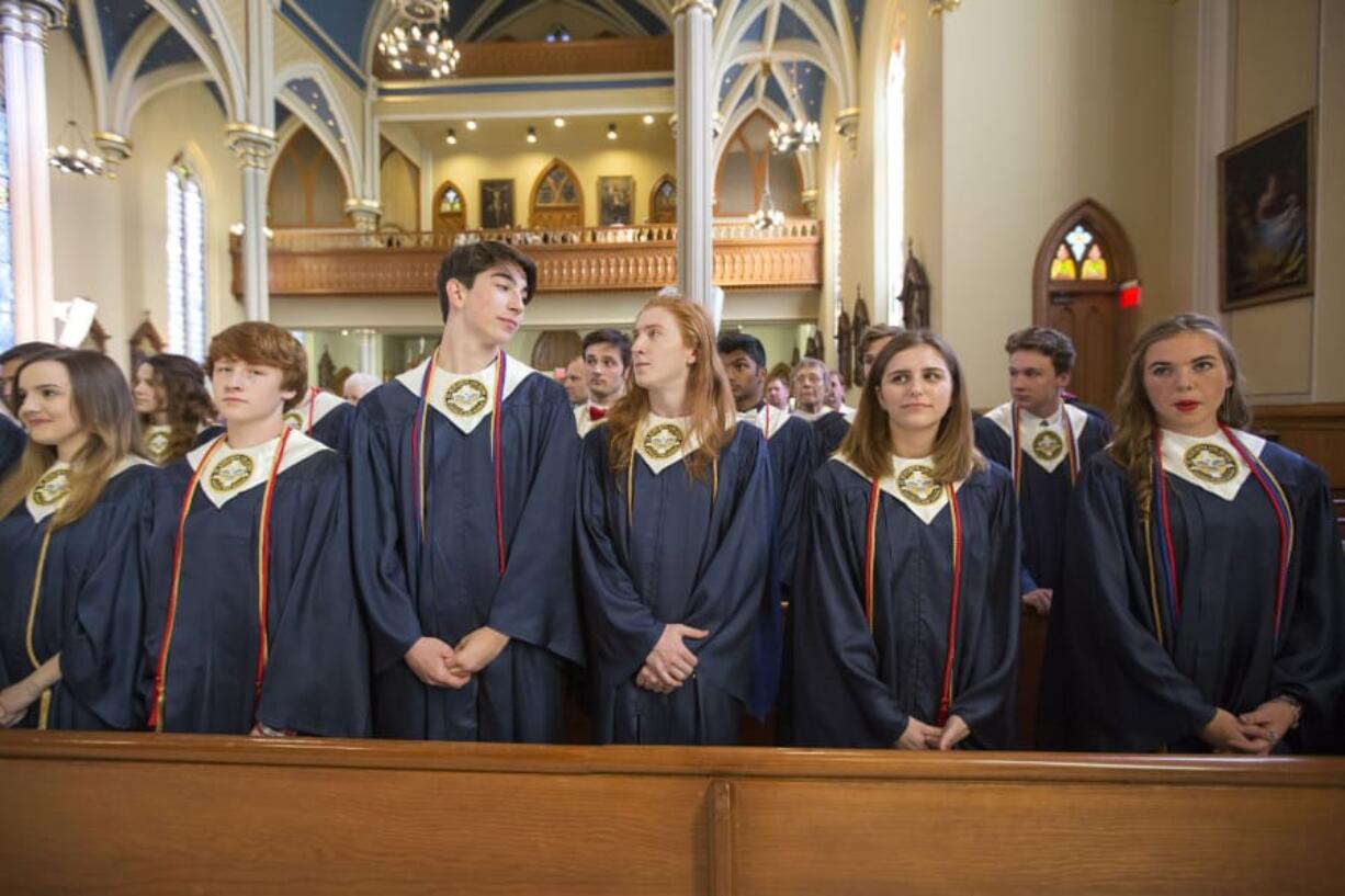 Seton Catholic College Preparatory High School’s graduating seniors stand in a pew Friday during their baccalaureate ceremony at Proto-Cathedral of St. James the Greater in Vancouver.