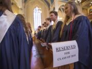 Seton Catholic College Preparatory High School’s graduating seniors stand in a pew Friday during their baccalaureate ceremony at Proto-Cathedral of St. James the Greater in Vancouver.